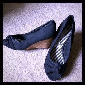 Black wedge open toe shoe.